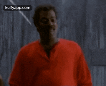 a blurry picture of a man in a red shirt
