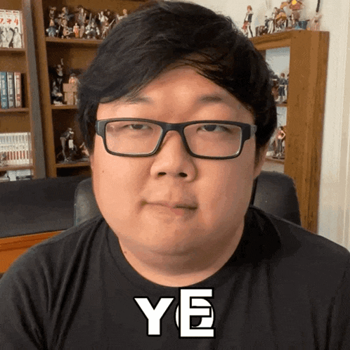 a man wearing glasses and a black shirt with ye written on it