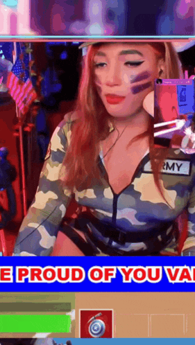 a woman in a camouflage outfit is sitting in front of a screen that says i proud of you