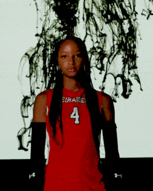 a woman wearing a red jersey with the number 4