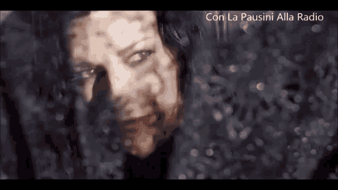 a close up of a woman 's face behind a window .