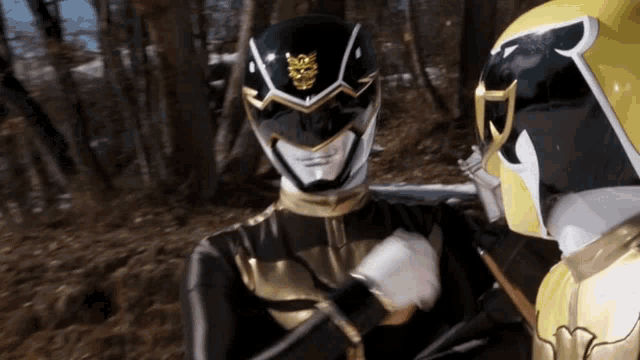 two power rangers are standing next to each other