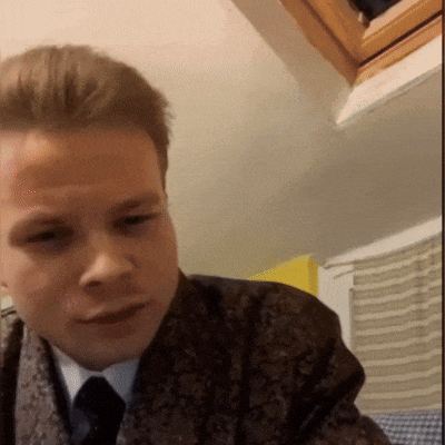 a man in a suit and tie is looking at something