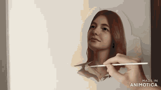 a hand is holding a brush and painting a woman 's face with the words made in animatica on the bottom