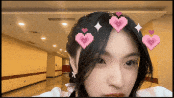 a pixelated image of a woman with hearts in her hair