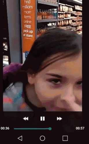 a girl is playing a video in a store with a sign that says find millions more items online free pick up at store