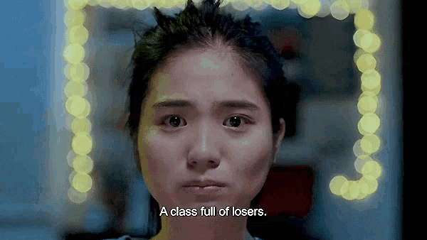 a close up of a woman 's face with the words a class full of losers above her