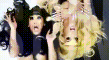 two women are standing next to each other and one has a black hat on