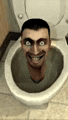 a man is sitting in a toilet with his head sticking out of it and smiling .