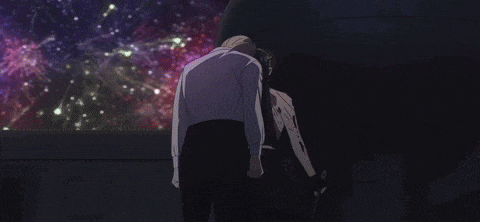 a man and woman are watching fireworks in the dark