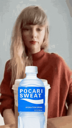 a bottle of pocari sweat sits next to a cup of coffee