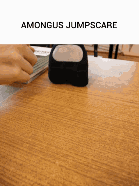 amongus jumpscare is written above a person 's hand