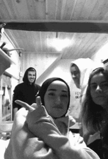 a group of young people are posing for a picture in a room .