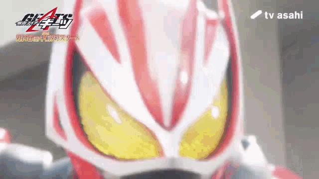 a close up of a person wearing a red and white helmet with yellow eyes .