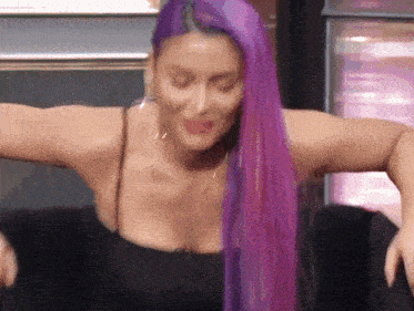 a woman with long purple hair is wearing a black tank top