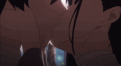 a man and a woman are kissing in front of a tree .