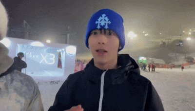 a man wearing a blue beanie with a snowflake on it