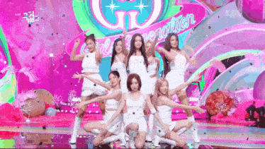 a group of women are dancing on a stage .
