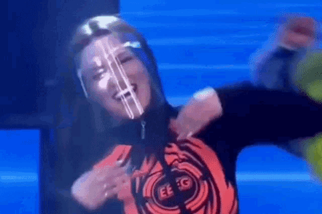 a woman wearing a face mask is dancing on a stage .