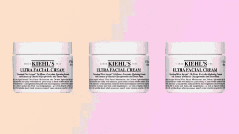 three bottles of kiehl 's ultra facial cream on a pink background
