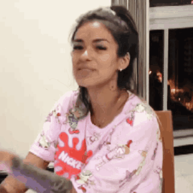 a woman wearing a pink shirt that says mickey mouse on it