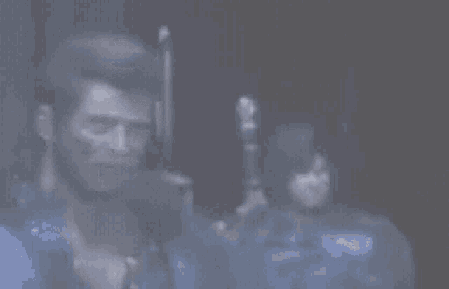 a blurry picture of a man holding a sword in a dark room