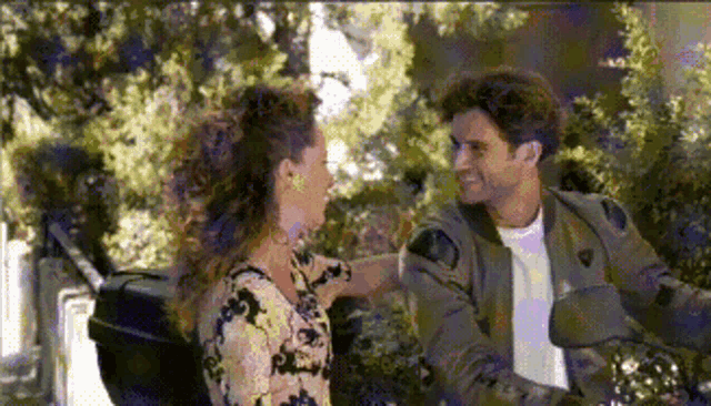 a man and a woman are looking at each other
