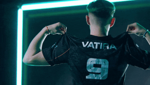 a man wearing a black jersey with the name vatira on the back