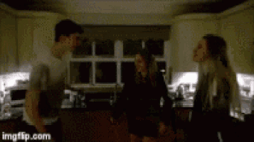 a group of people are standing in a kitchen with imgflip.com in the lower right corner
