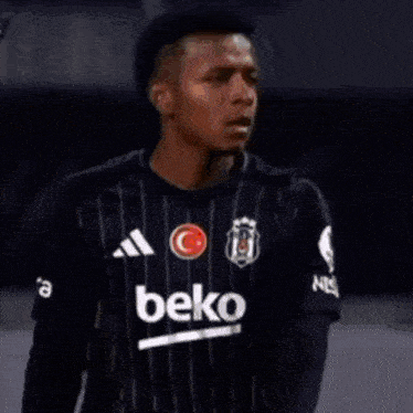 a soccer player wearing a beko jersey is celebrating on the field