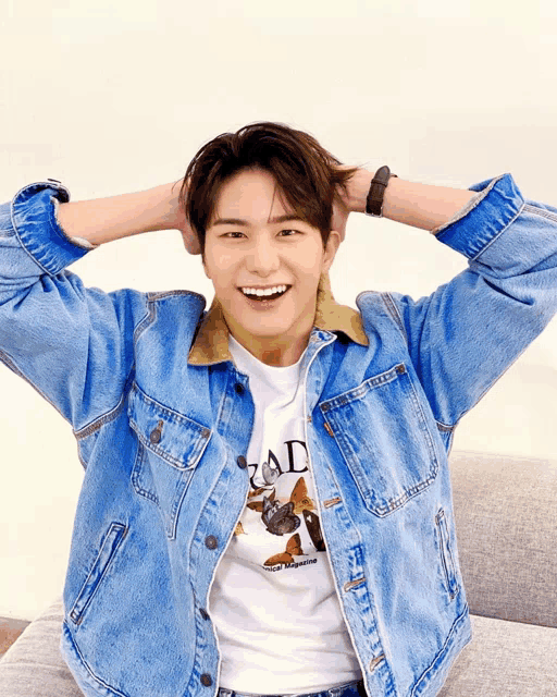 a young man wearing a denim jacket and a t-shirt that says rad