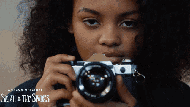a poster for selah & the spades shows a young girl holding a camera
