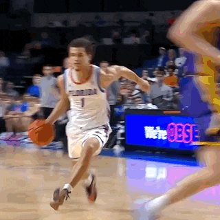a basketball player with the number 1 on his jersey runs with the ball