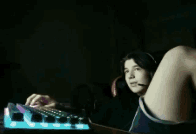 a person wearing headphones is playing a video game on a keyboard