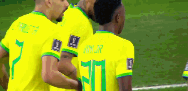 a group of soccer players are hugging each other and one of them has the number 11 on his back