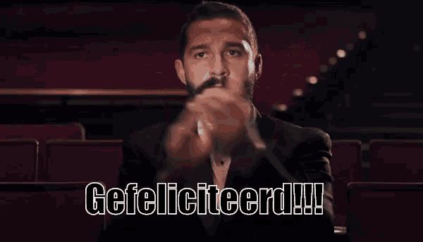 a man in a tuxedo and bow tie is saying gefeliciteerd