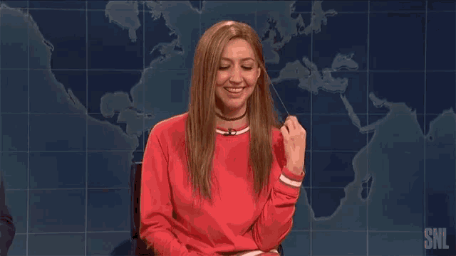 a woman in a red sweater is giving the middle finger