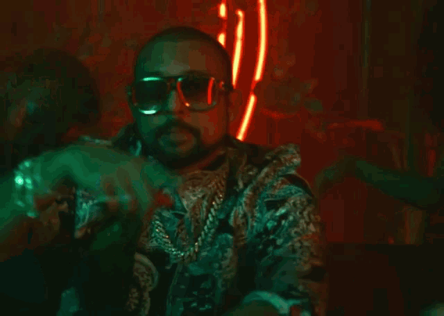 a man wearing sunglasses says your body insane in a video