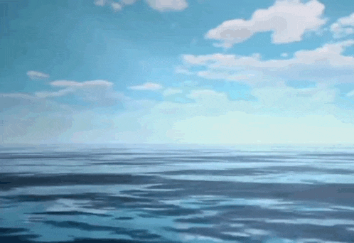a large body of water with a blue sky in the background