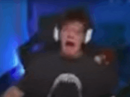 a blurry picture of a man wearing headphones while sitting in a chair .