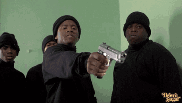 a group of men are standing in front of a green wall with the words brown sugar on the bottom right