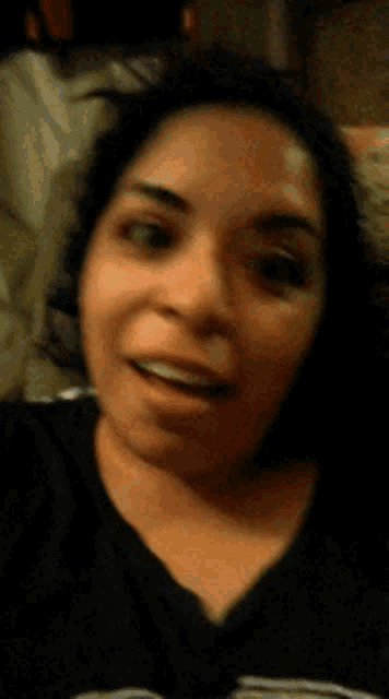a close up of a woman 's face with a black shirt on