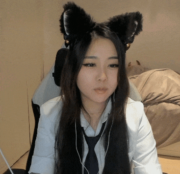 a woman wearing a cat ear headband and a tie