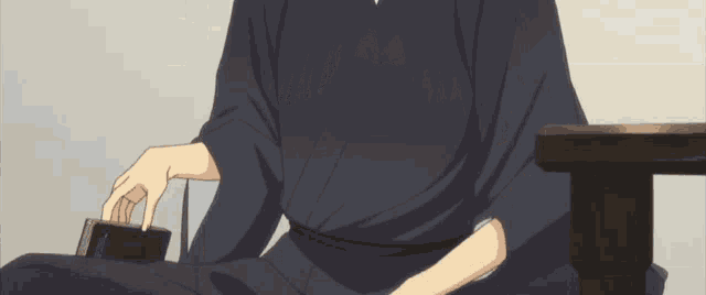 a man in a kimono is holding a book in his hand