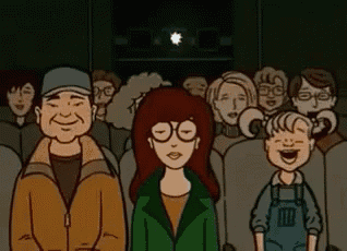 a cartoon of a group of people watching a movie in a theater .