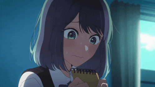 a girl with short hair is holding a notebook and making a funny face
