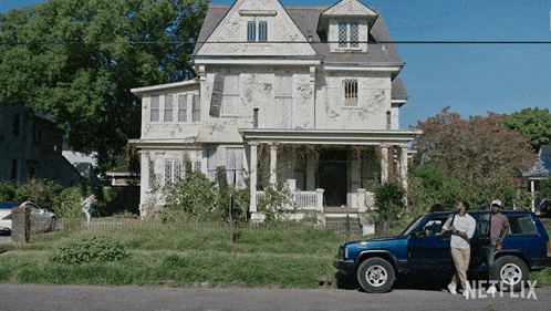 a blue jeep is parked in front of a large white house with a netflix logo
