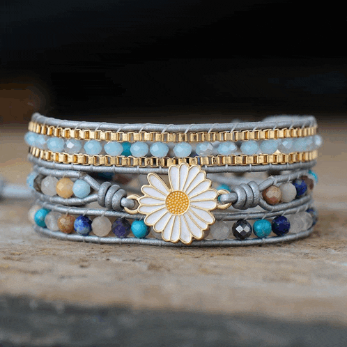 a beaded bracelet with a white flower on it