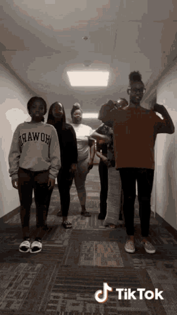 a group of people are standing in a hallway with a tiktok watermark