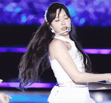 a woman with long hair is wearing a white dress and a headband
